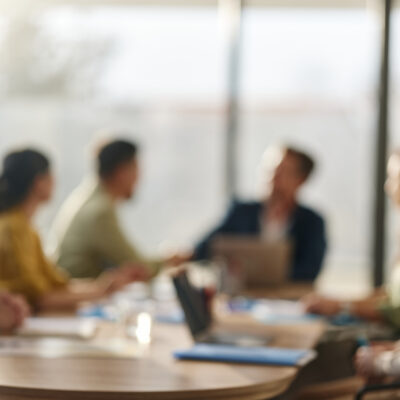 Blurry picture of meeting attendees round table